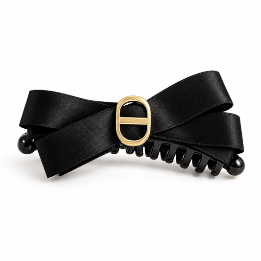 Black satin bow claw hair clip with gold-tone accent on a clean white background
